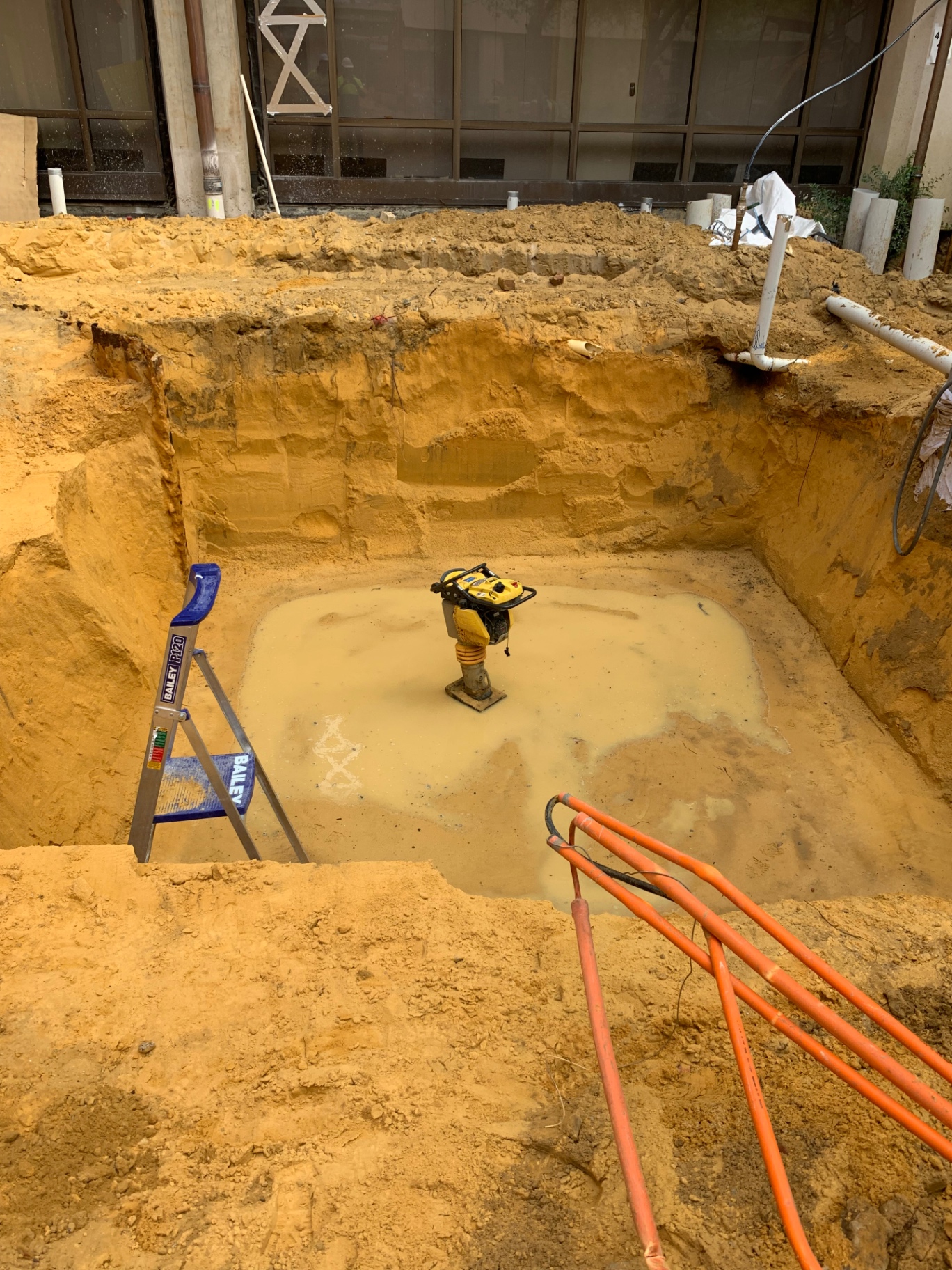 1.8-tonne mini excavator preparing footings in a tight backyard