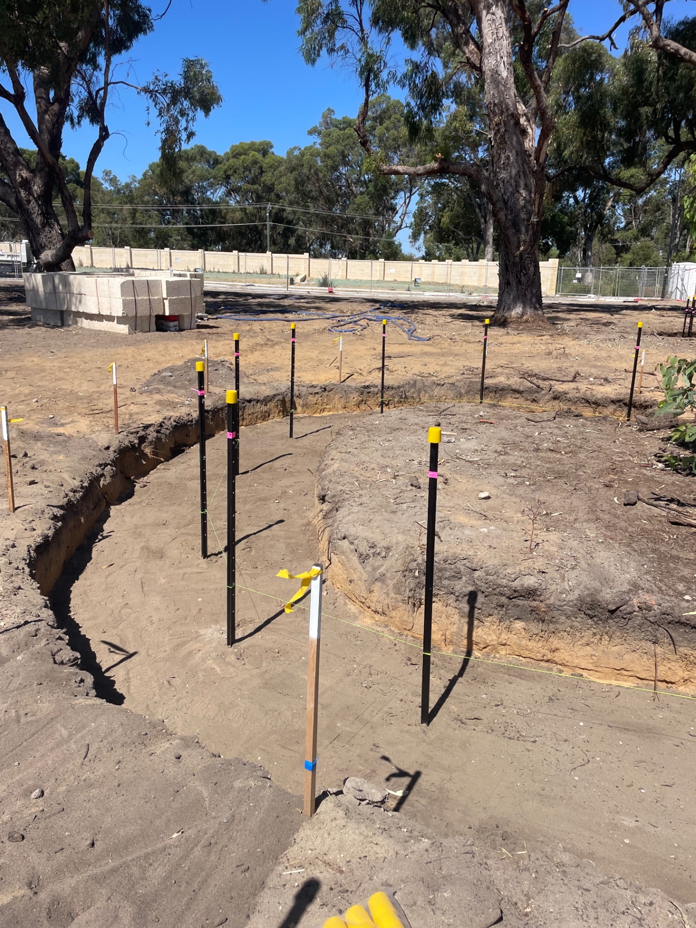Mini excavator digging a trench on a Perth residential site